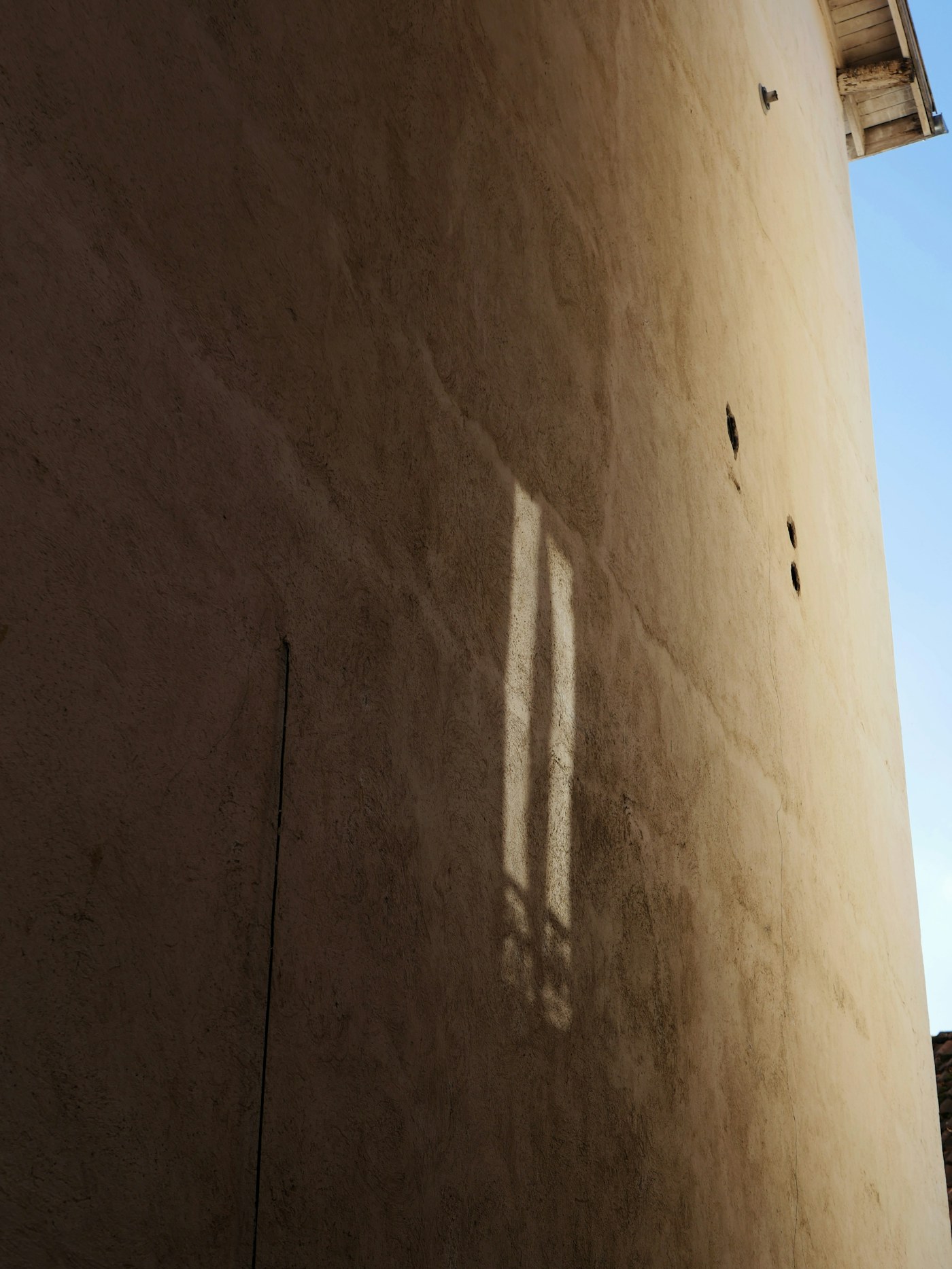 Inspector documenting a foundation wall with a printed floor plan